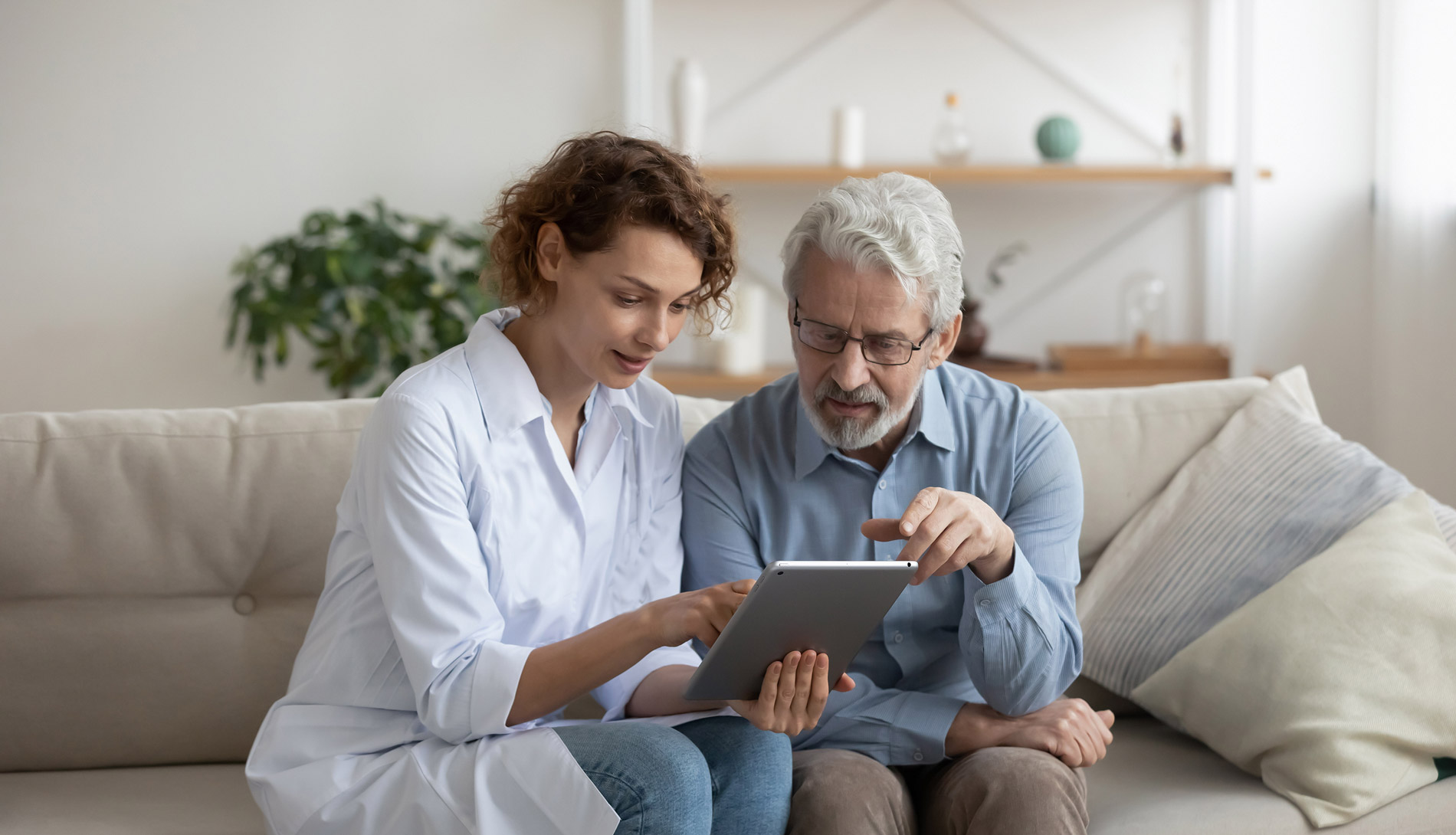 medical technician showing a patient results on an iPad