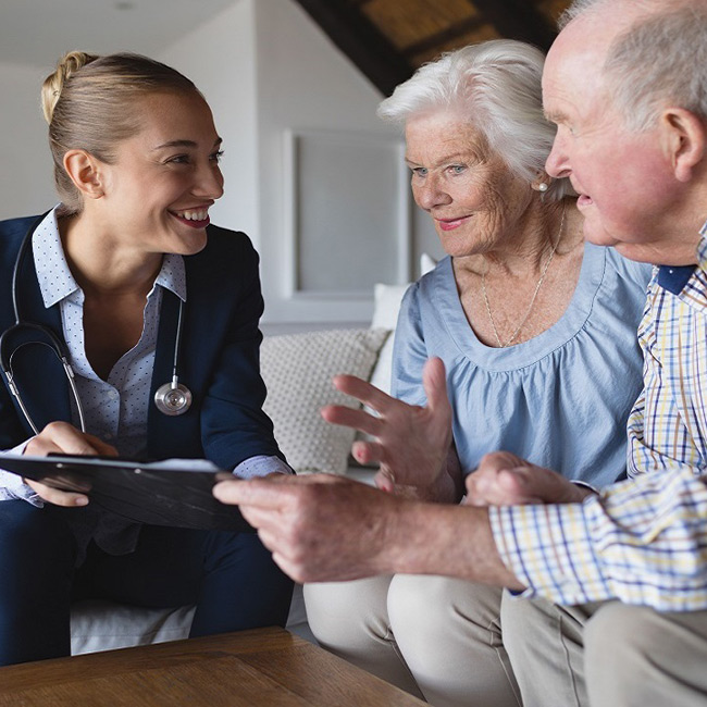 Medical technician consulting with a senior couple